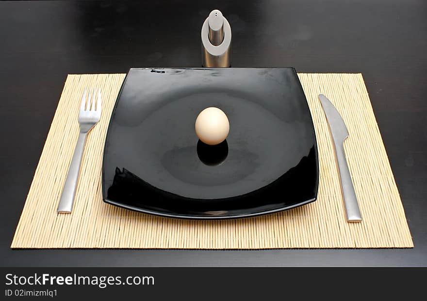 Dinner egg in a black plate