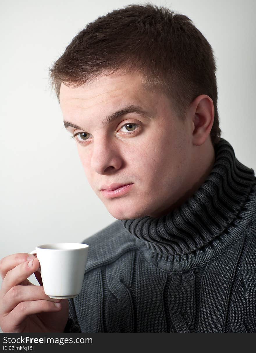 Young man with a cup coffee