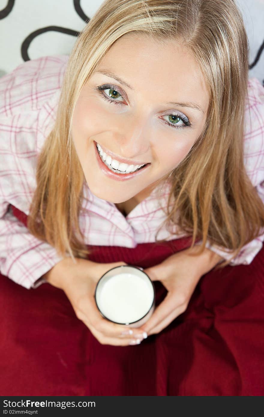 Woman in bed with glass of milk