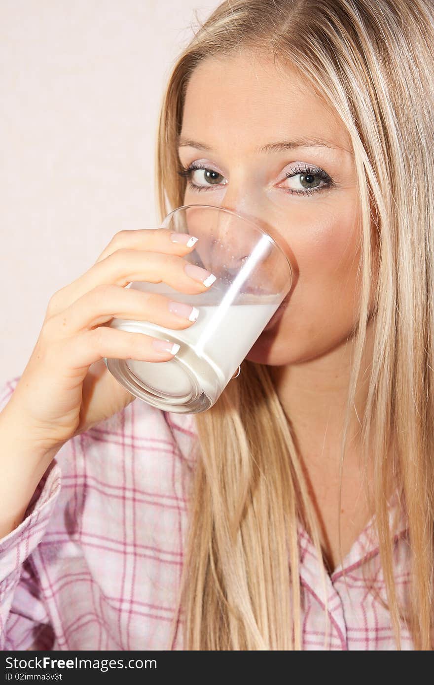 Woman in bed with glass of milk