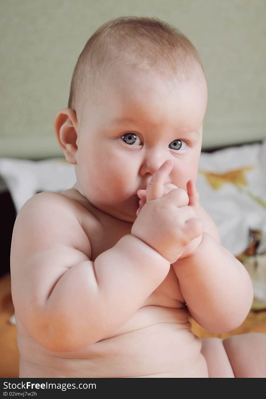 Portrait of beautiful little boy, looking with curiosity large blue eyes on the world