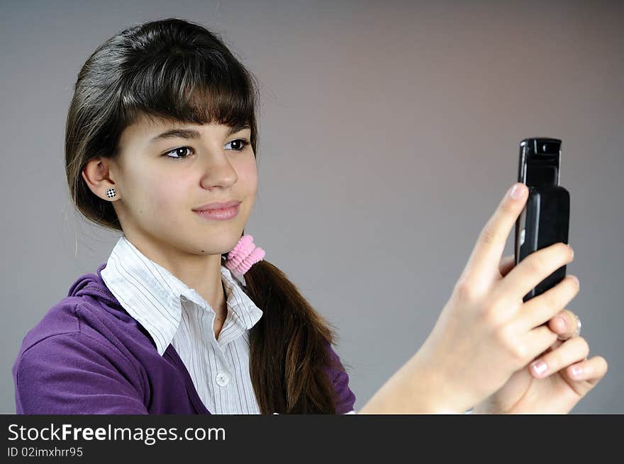 White teen creating photos with her phone. White teen creating photos with her phone