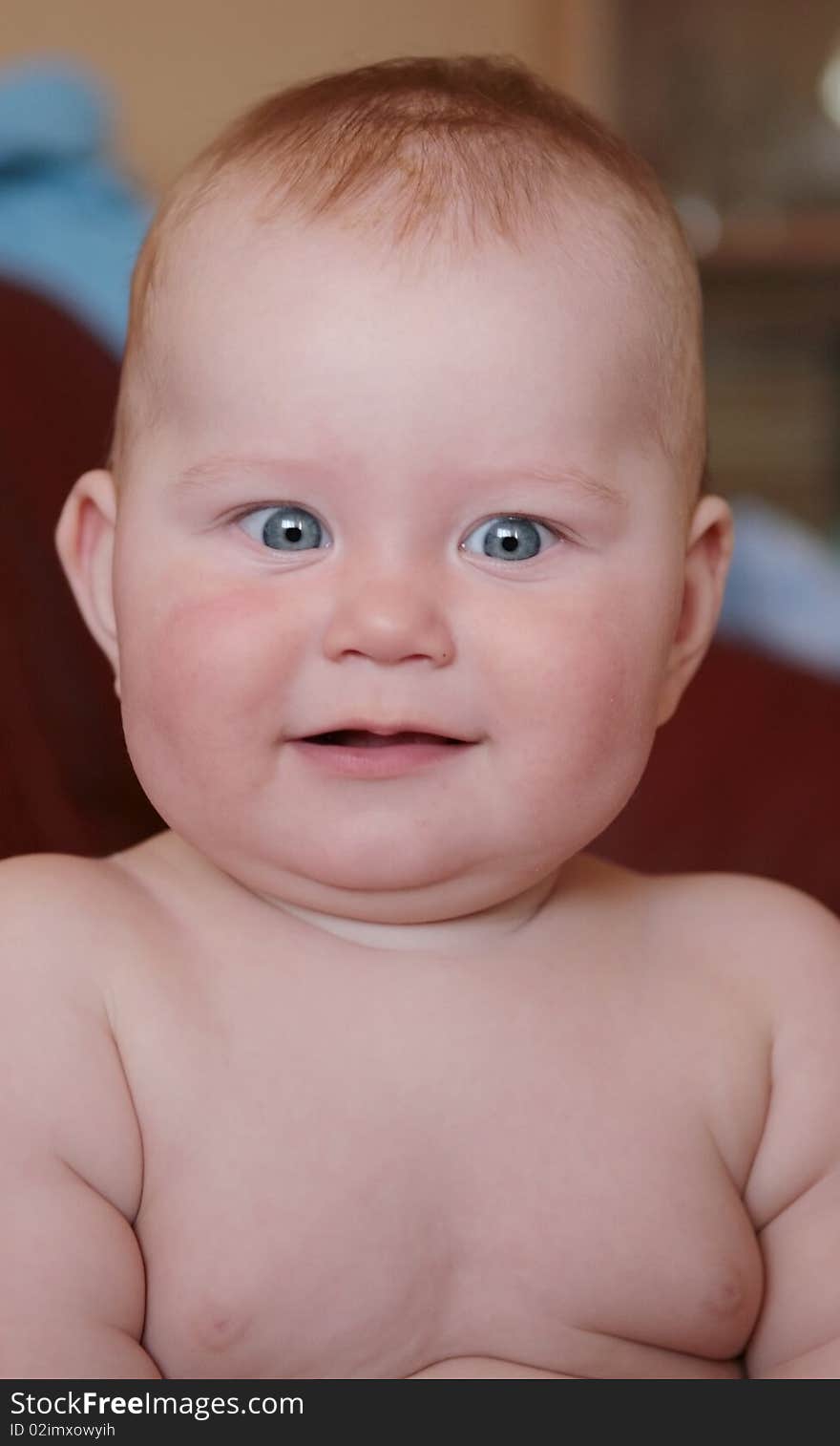 Portrait of beautiful little boy, looking with curiosity large blue eyes on the world