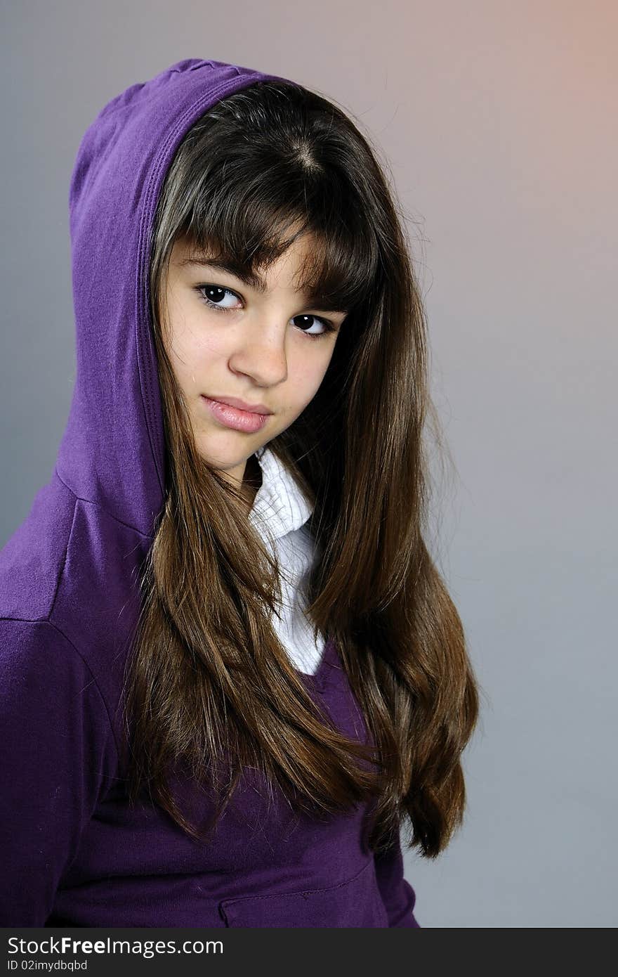 Beautiful teen posing in studio with purple blouse. Beautiful teen posing in studio with purple blouse