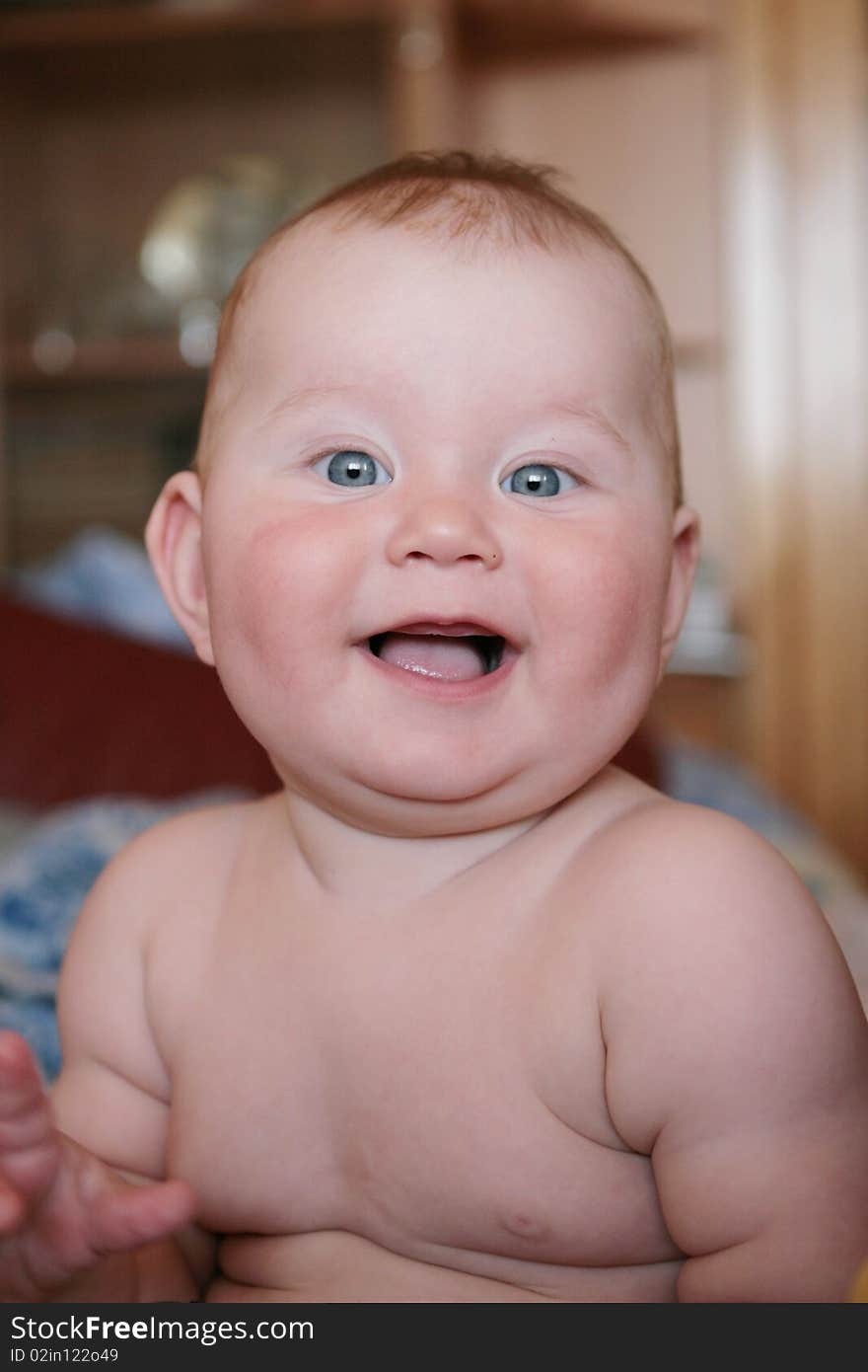 Portrait of beautiful little boy, looking with curiosity large blue eyes on the world