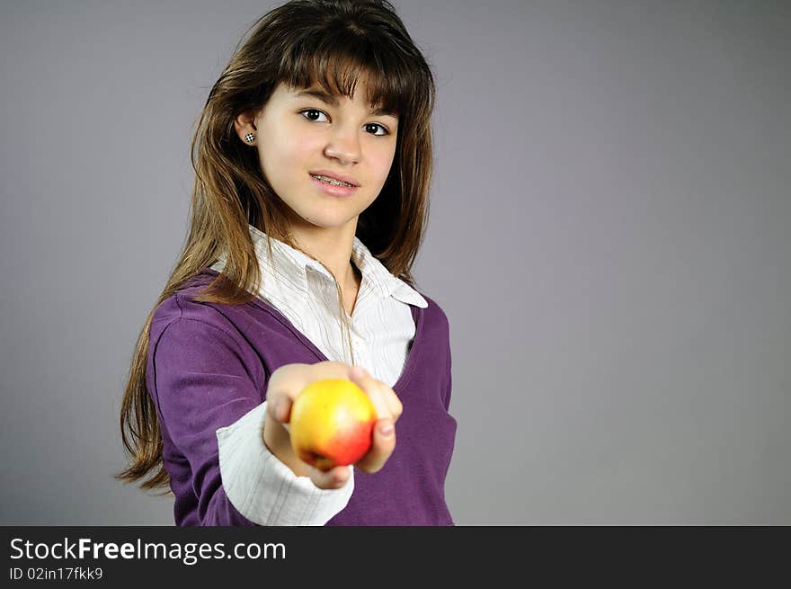 Beautiful teenager giving healthy fruit to her friends. Beautiful teenager giving healthy fruit to her friends