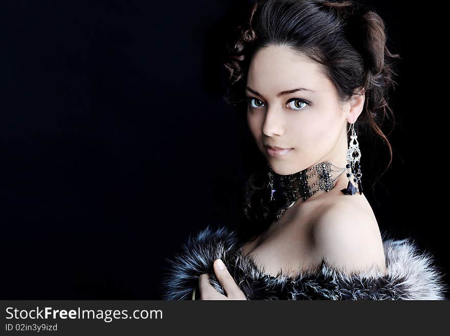 Portrait of a beautiful woman over black background. Portrait of a beautiful woman over black background..