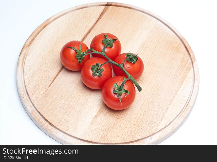 Fresh tomatoes on a wooden worktop. Fresh tomatoes on a wooden worktop