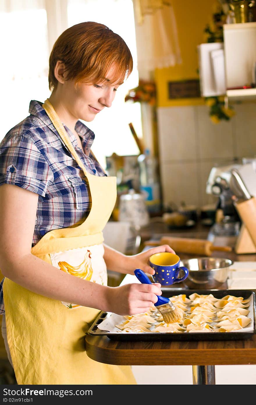 Young woman makes croissant with peach. Young woman makes croissant with peach