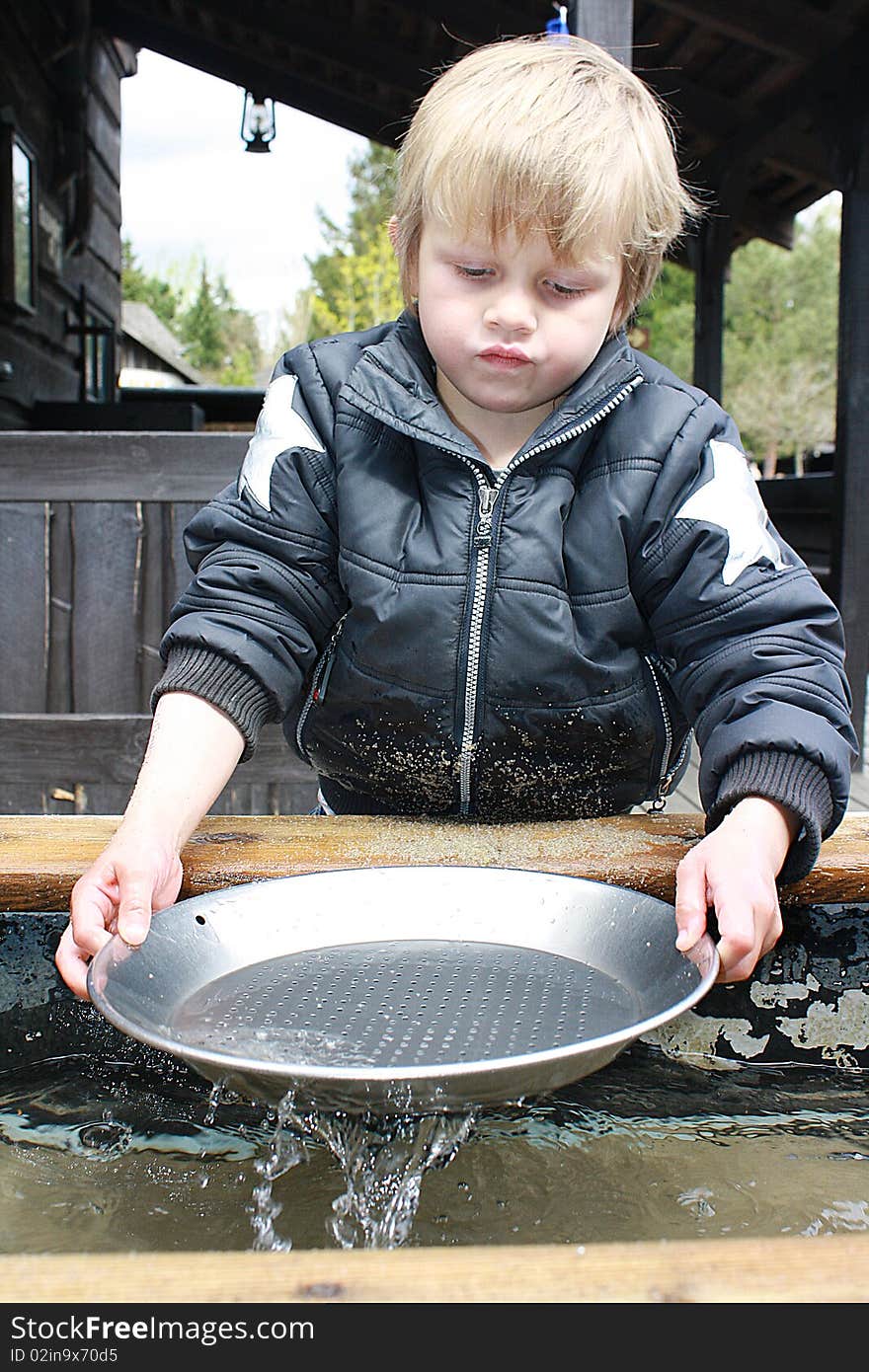 Boy trying his luck at panning, Legoland, Billund, Denmark. Boy trying his luck at panning, Legoland, Billund, Denmark