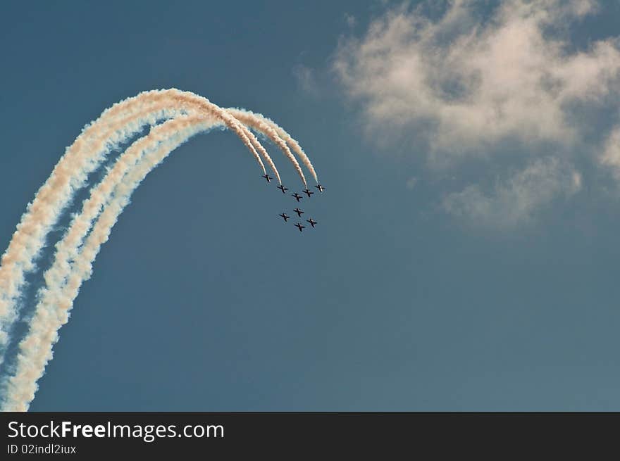 RAF Red Arrows aerobatics team,Create White Arc Against Blue Sky. RAF Red Arrows aerobatics team,Create White Arc Against Blue Sky