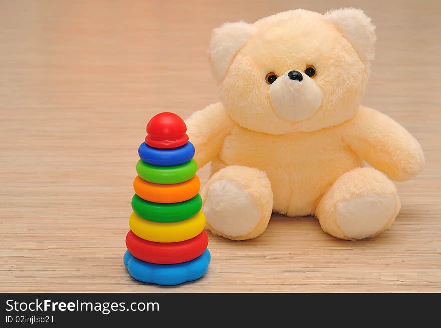 Teddy bear sitting on a hardwood floor. Teddy bear sitting on a hardwood floor.