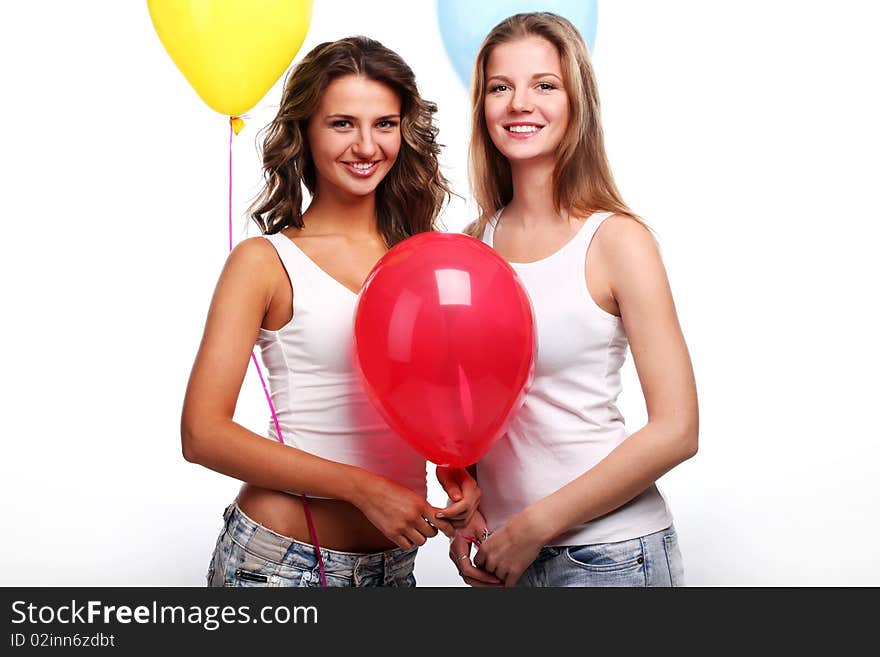 Two beautiful young girlfriends with color balloons. Two beautiful young girlfriends with color balloons