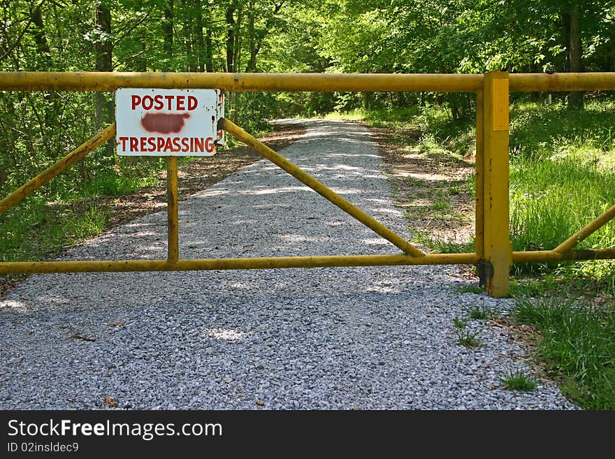 Sign, Posted No Trespassing, with the 'no' painted out. Sign, Posted No Trespassing, with the 'no' painted out