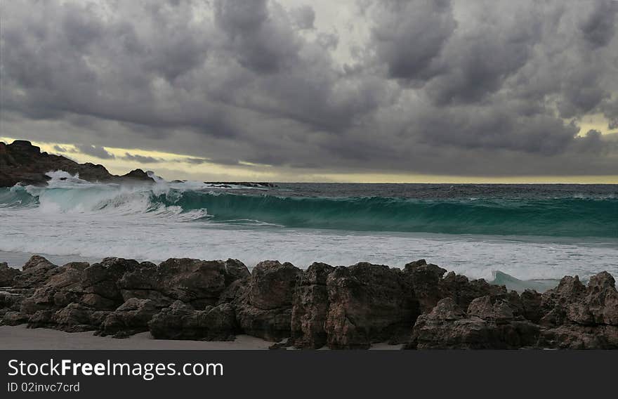 Landscape view of breaking wave on a stormy morning. Landscape view of breaking wave on a stormy morning.