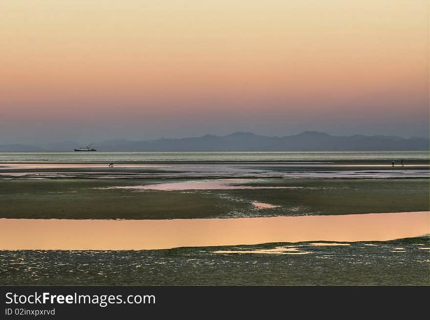 A Sunset near Marahau and Abel Tasman National Park on the South Island of New Zealand. A Sunset near Marahau and Abel Tasman National Park on the South Island of New Zealand