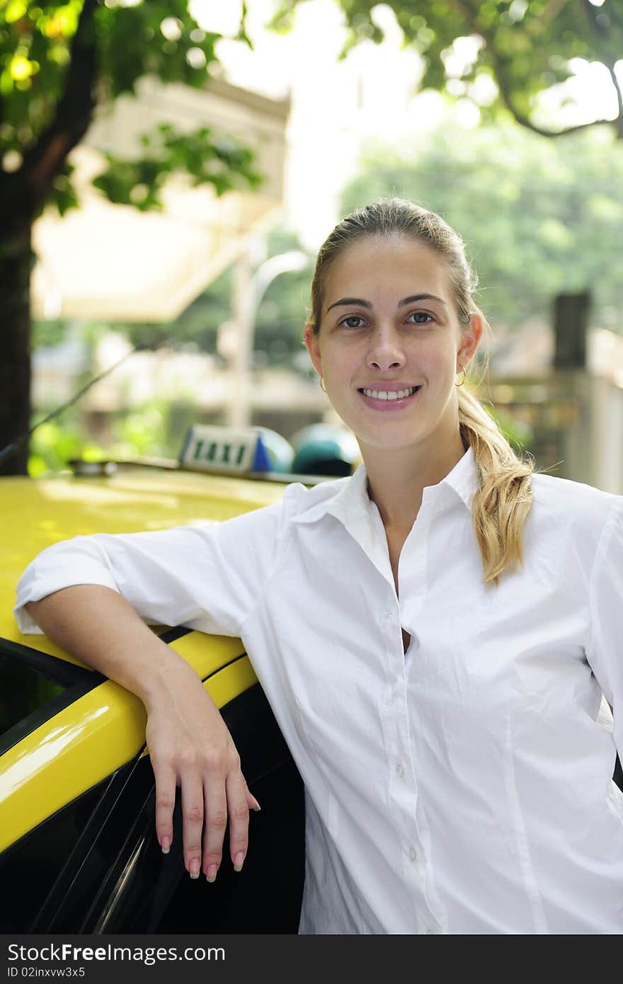 Portrait Of A Female Taxi Driver With Her New Cab