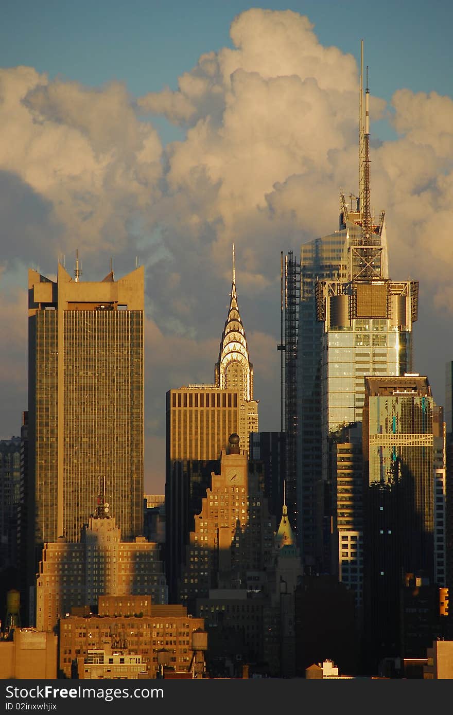 View of New York City Skyline, with the Chrysler Building spire centered in the photo. Storm clouds have just passed the city and float beyond.