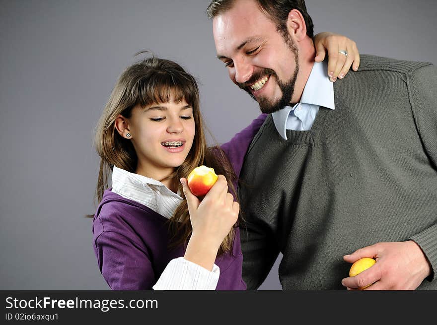 Beautiful white happy family enjoying apples. Beautiful white happy family enjoying apples