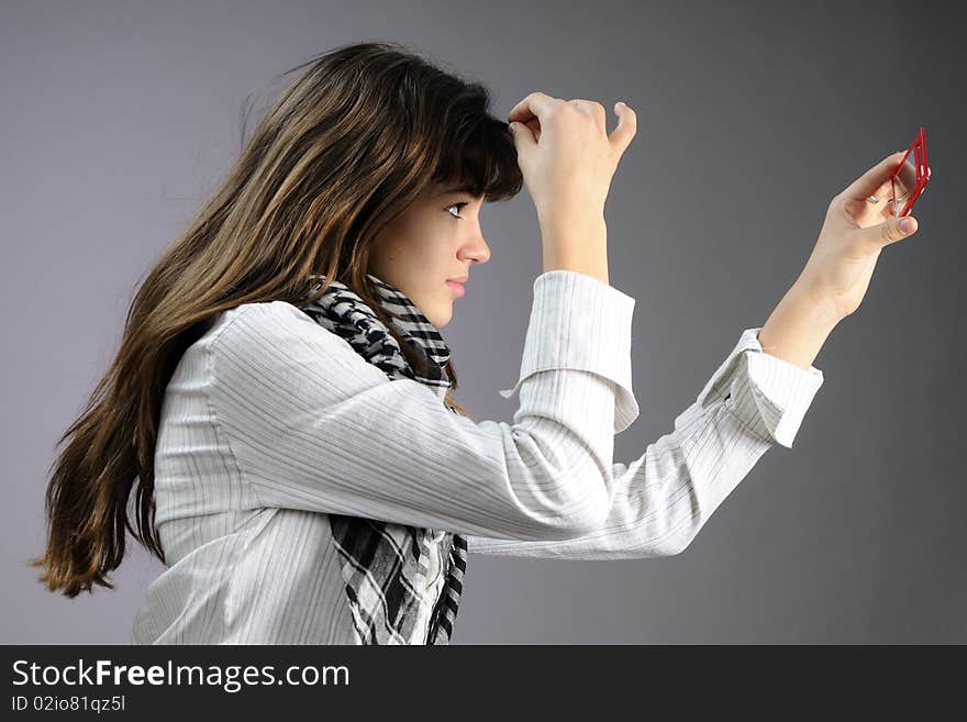 Caucasian teenager preparing for photos in studio. Caucasian teenager preparing for photos in studio