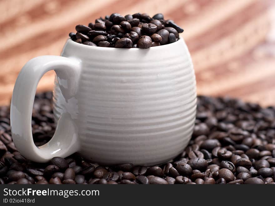 Coffee beans in a cup with ethnic mood