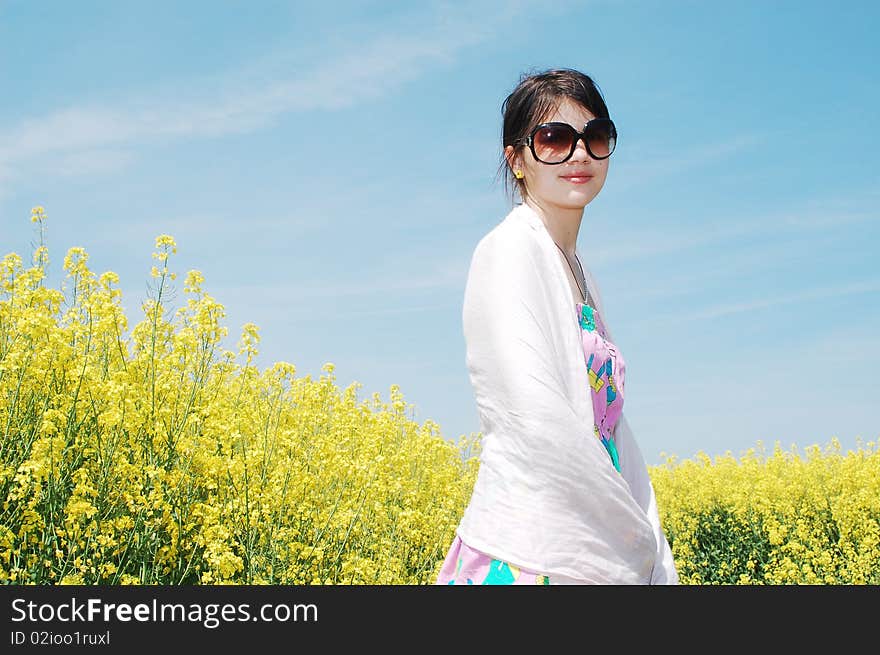 Young beautiful girl enjoying a sunny day on canola field. Young beautiful girl enjoying a sunny day on canola field