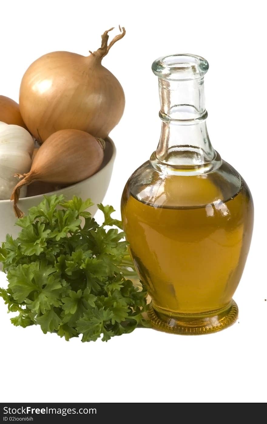 Bottle of olive oil with onion and parsley, isolated. Bottle of olive oil with onion and parsley, isolated