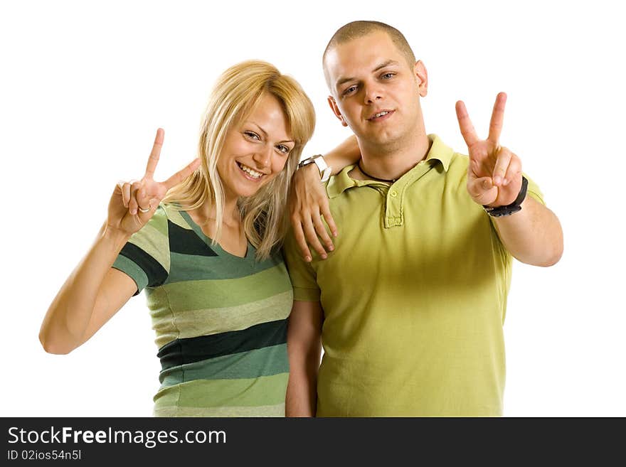 Couple making their victory sign over white background. Couple making their victory sign over white background