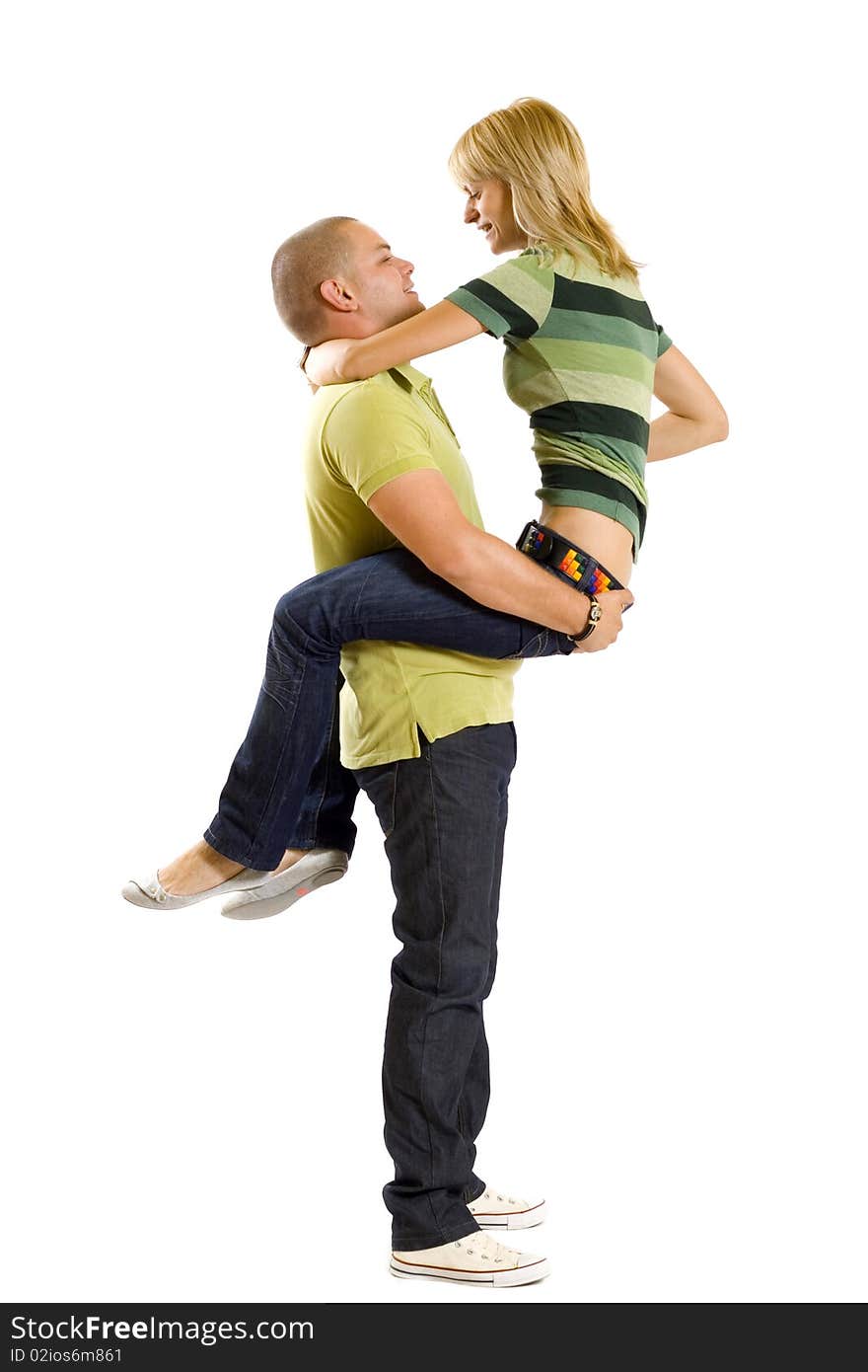 Young man holding his girlfriend in the air over white. Young man holding his girlfriend in the air over white