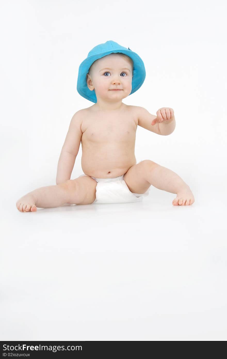 Lovely infant in blue hat on white background. Lovely infant in blue hat on white background.