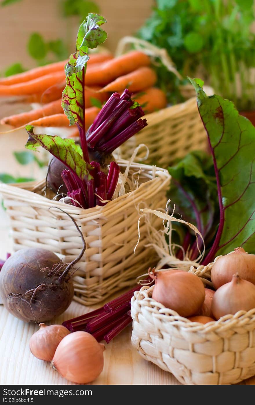 Fresh vegetables in baskets on a wooden table