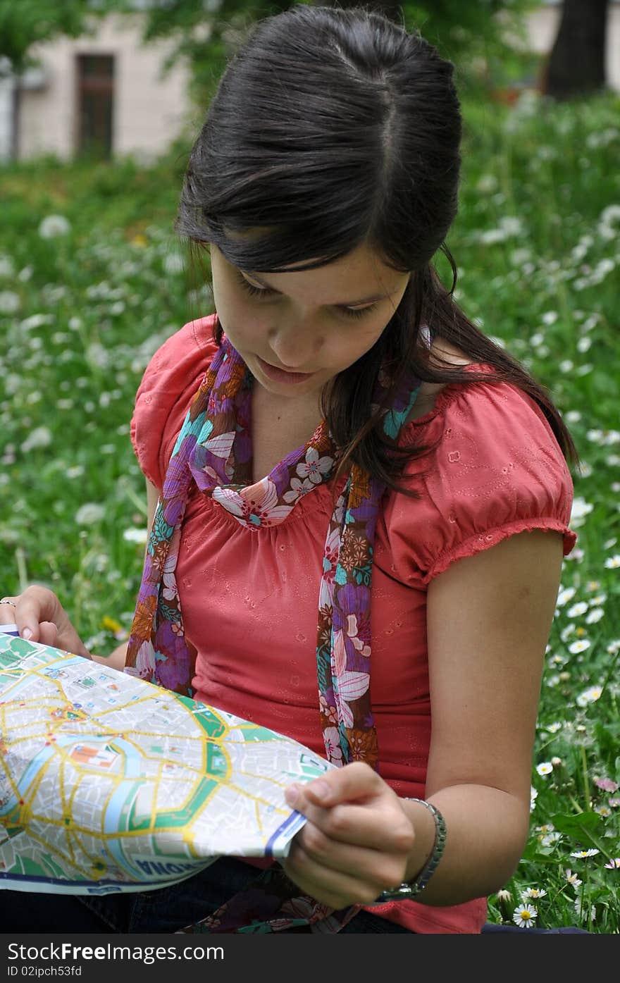 Beautiful girl with a city map, travel