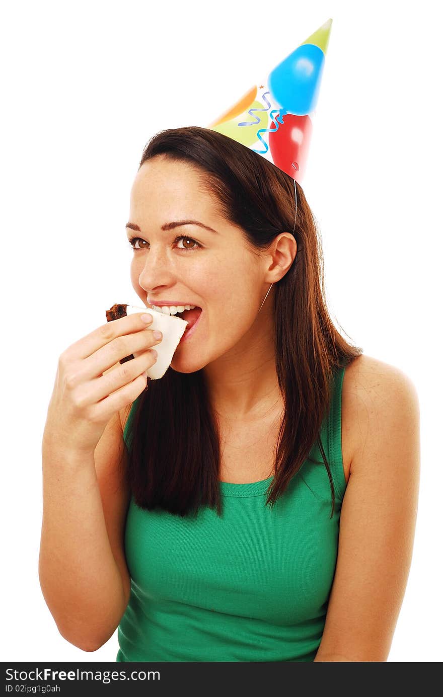 Woman biting on piece of cake wearing party hat. Woman biting on piece of cake wearing party hat