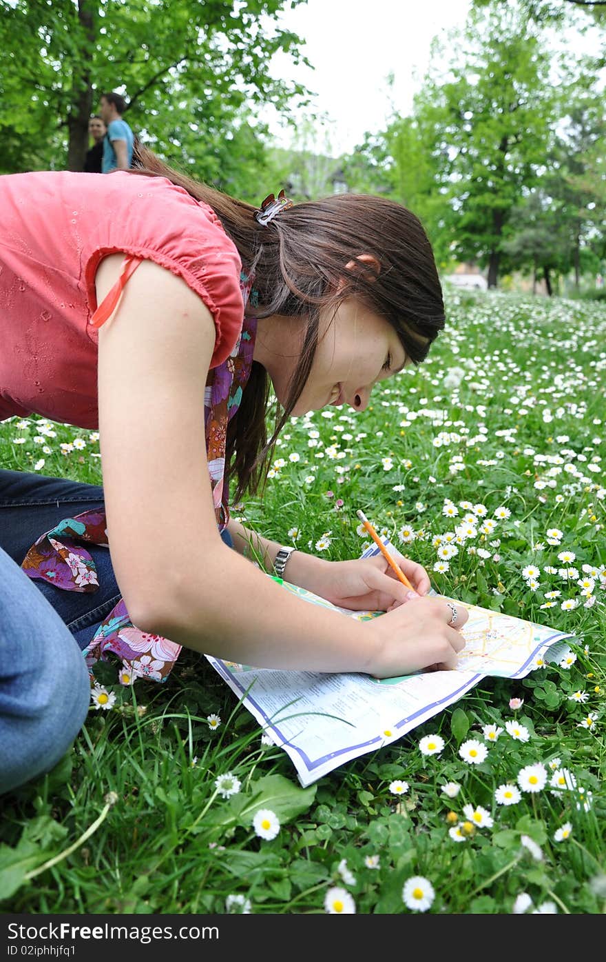 Young student learns in the city park