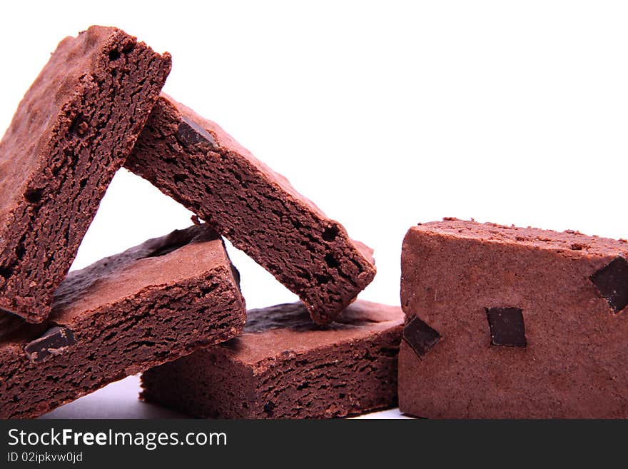 Stack of freshly made chocolate brownies on a white background. Stack of freshly made chocolate brownies on a white background.