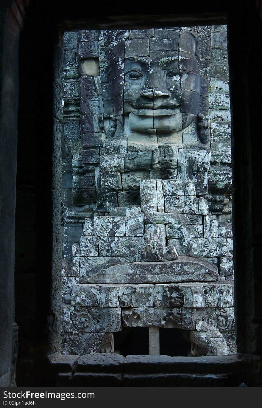 View through door entrance to a statue of bayon