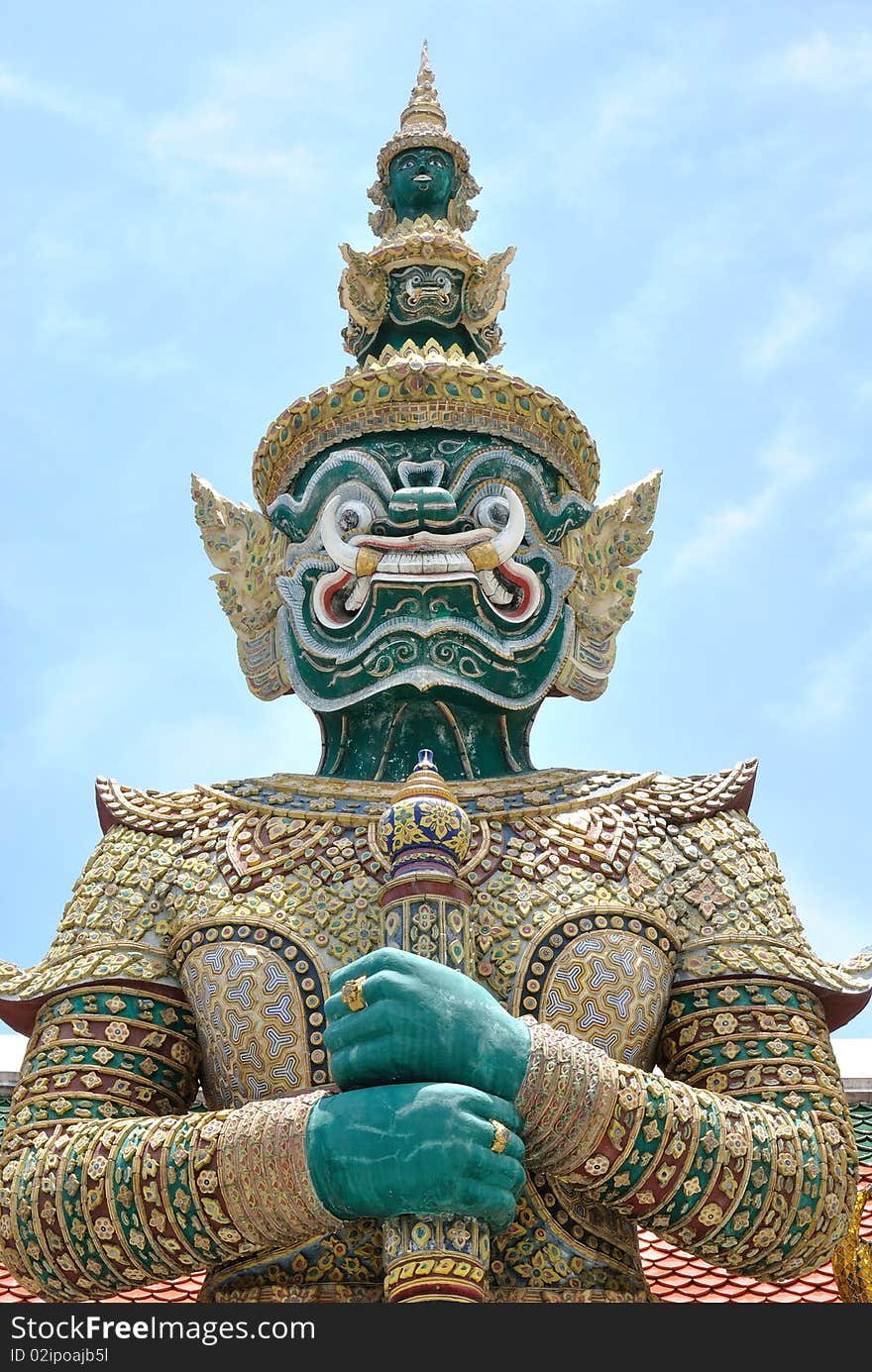 Thai giant statue stand in front of temple at emerald buddha temple. onece of historical statue in thailand.