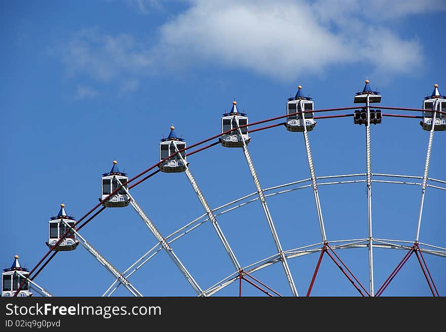 Cabins of the big  wheel in park of rest against the blue sky. Cabins of the big  wheel in park of rest against the blue sky