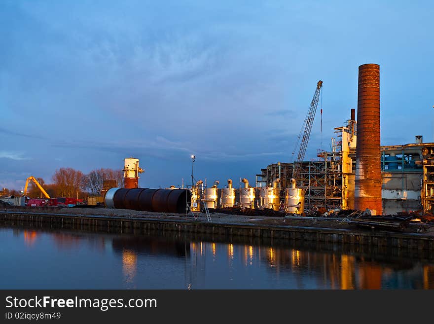 Demolition of an industrial factory at sunset