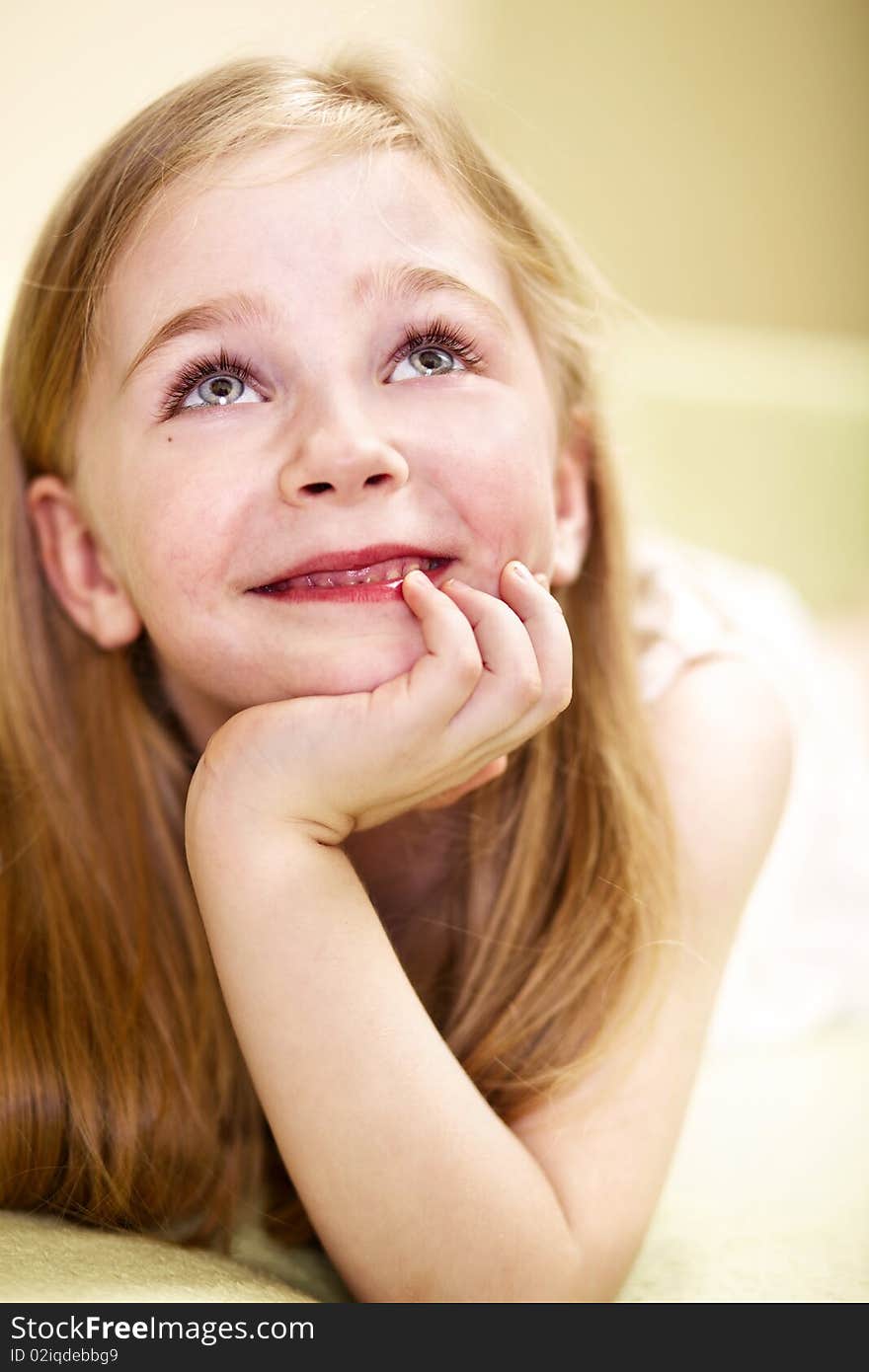 Happy little girl looking up; closeup