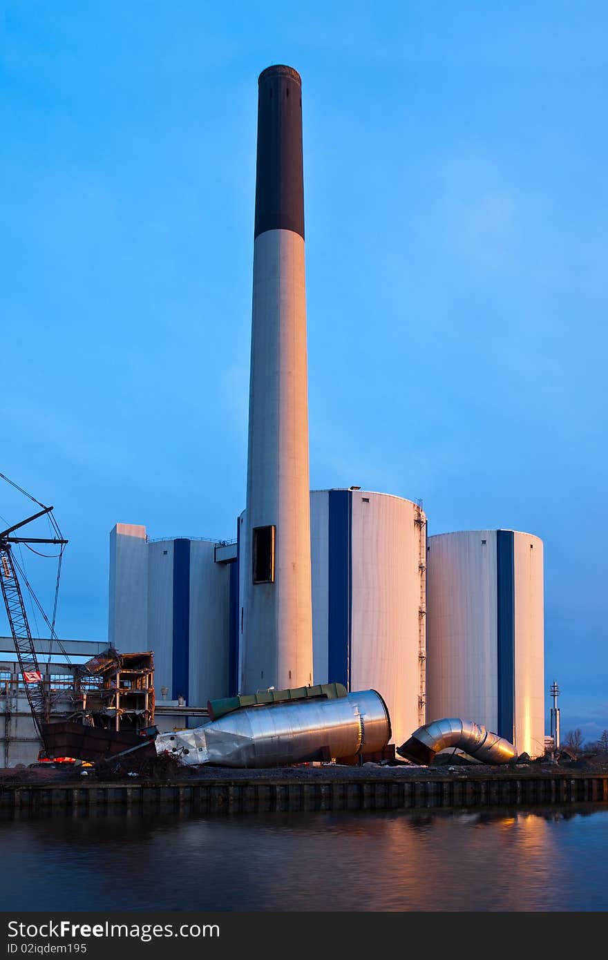 Demolition of an industrial factory at sunset