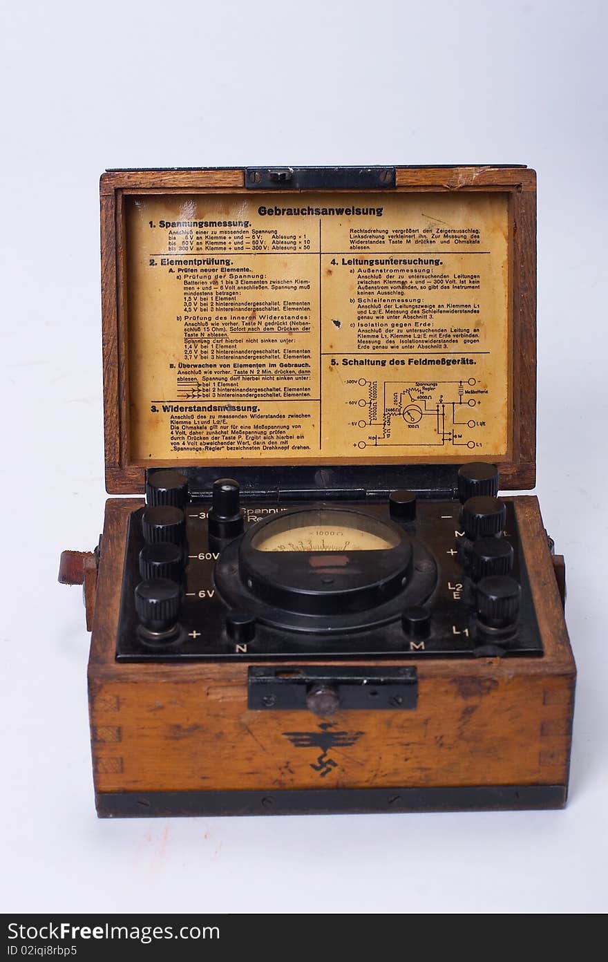 The ancient brown voltmeter in a wooden case