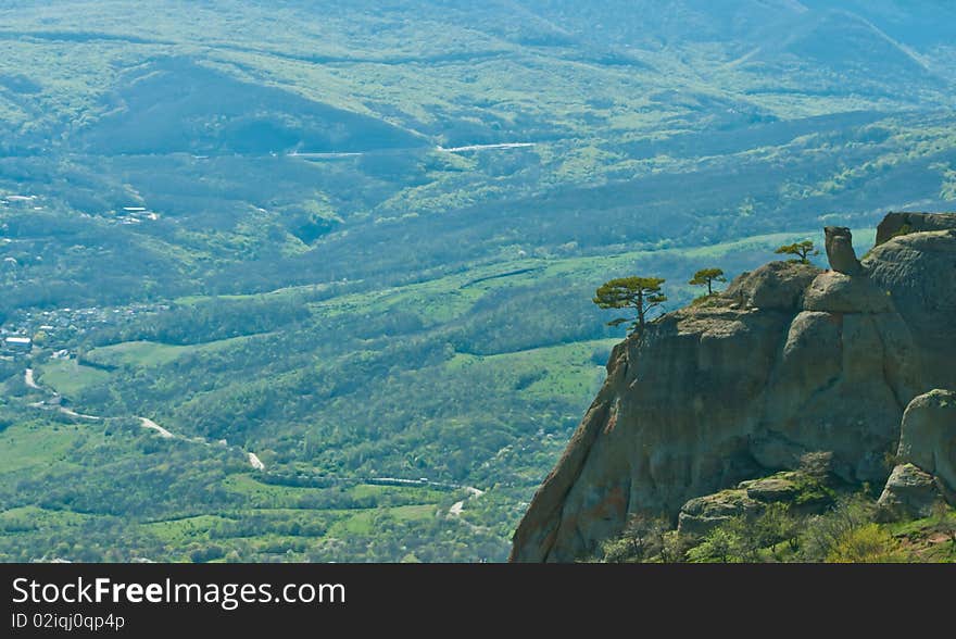 A bird view of a rock with a tree on it and valley in Crimea, Ukraine. A bird view of a rock with a tree on it and valley in Crimea, Ukraine