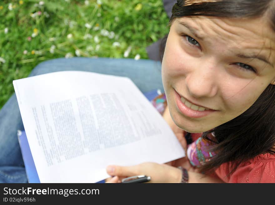 Young student learns in the city park