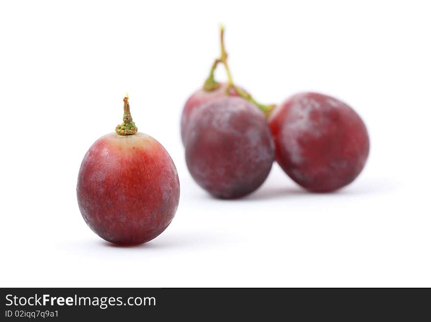 A grape isolated from other over white background. A grape isolated from other over white background.