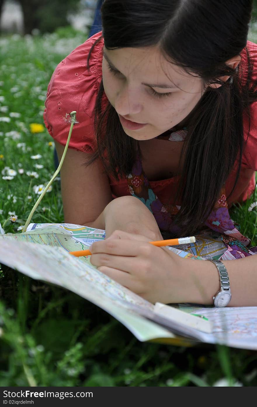 Young student learns in the park