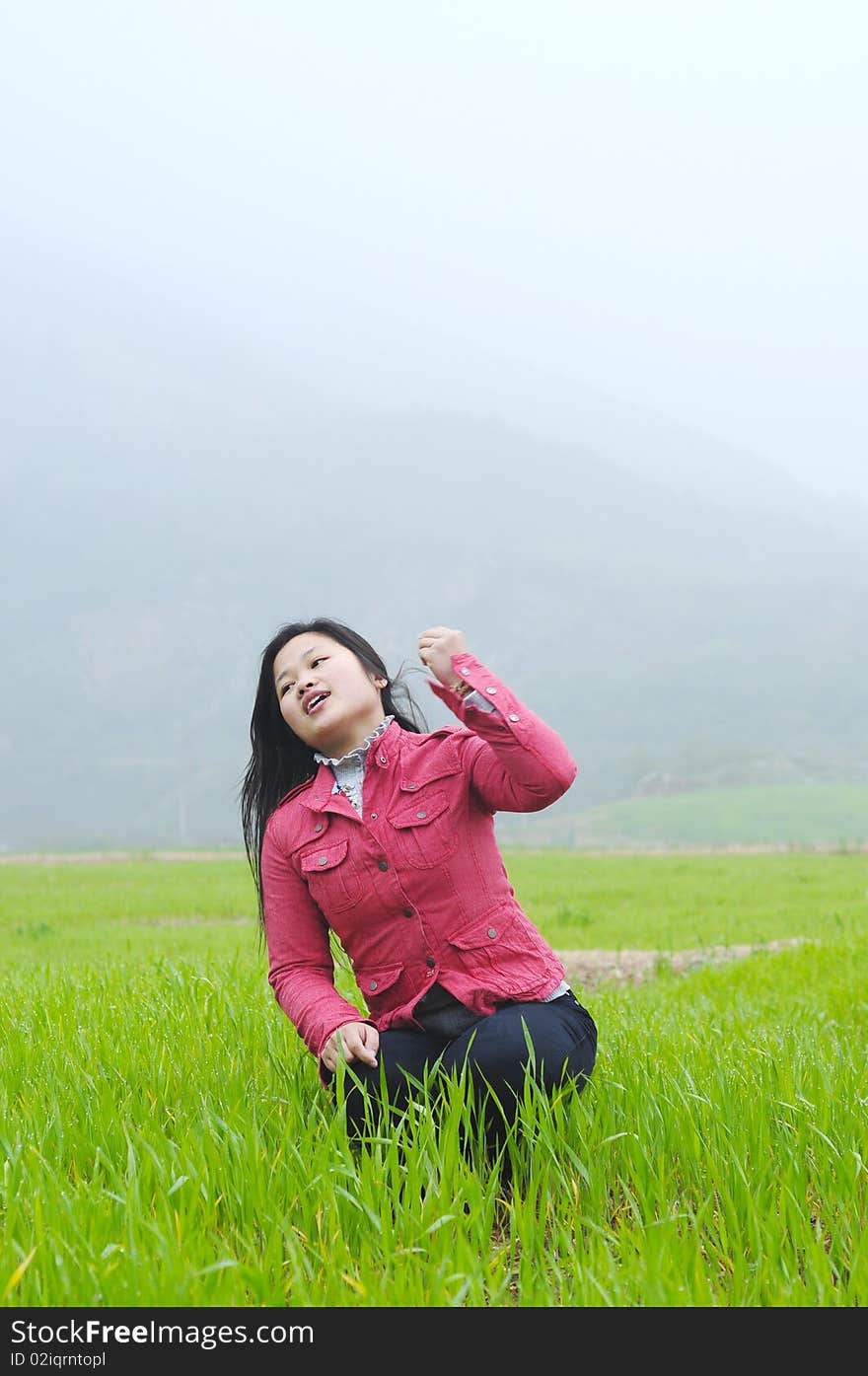 A adult female in the green field.