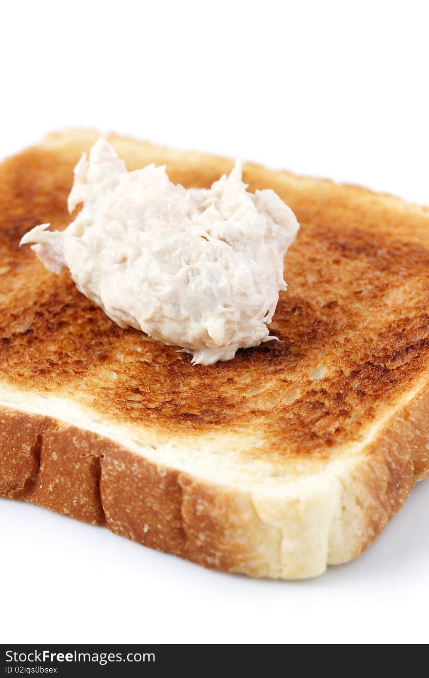 A piece of baked bread with mayonnaise tuna isolated on white background. A piece of baked bread with mayonnaise tuna isolated on white background.