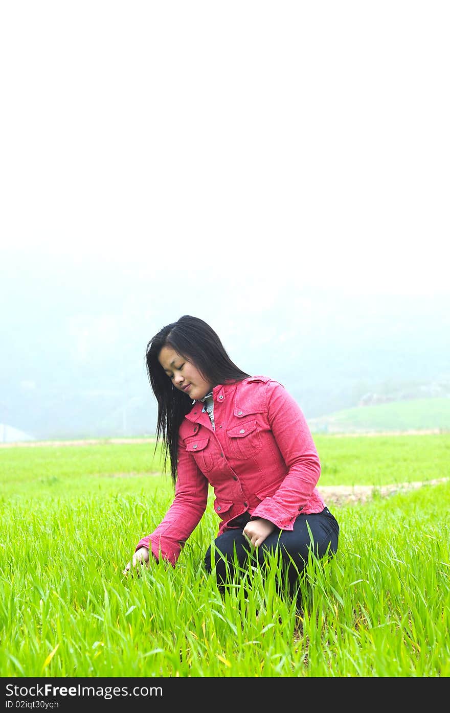 A adult female in the green field.