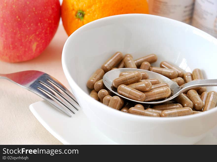 Spoon taking medicine capsules